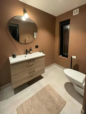 a bathroom with a toilet and a sink and a mirror at Modern Cabin Near Auersvatn And Ski Trails in Hovden
