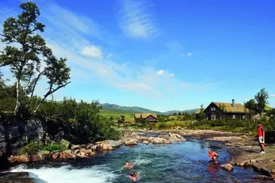 a group of people swimming in a river at Hovden Fjellpark 71 in Hovden