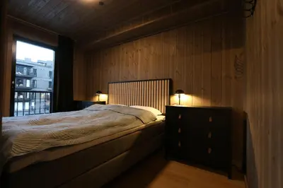 a bedroom with a bed with a dresser and a window at Stylish apartment in Hemsedal, Ski in-ski out in Hemsedal