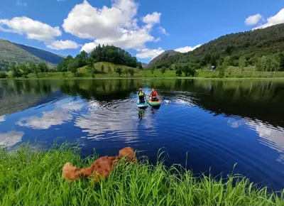 two people in kayaks on a lake at Nesvika nature reserve Apartment only 20 min away from Bergen in Bergen
