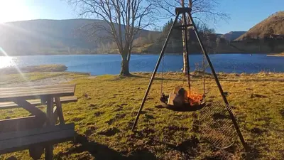 a swing in a field next to a lake at Nesvika nature reserve Apartment only 20 min away from Bergen in Bergen