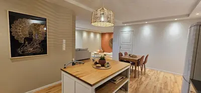 a kitchen and dining room with a table and chairs at Helgøya Hideaway