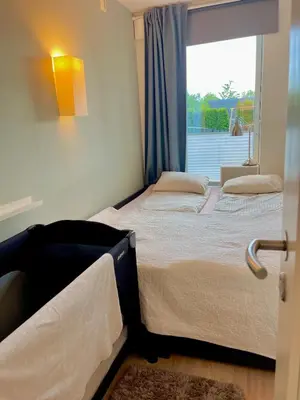 a bedroom with two beds and a window at Floien City Apartment -Free parking in Bergen