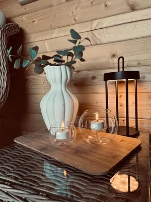 a table with two vases and candles on it at Unique and romantic Lakeside Experience in Vossevangen