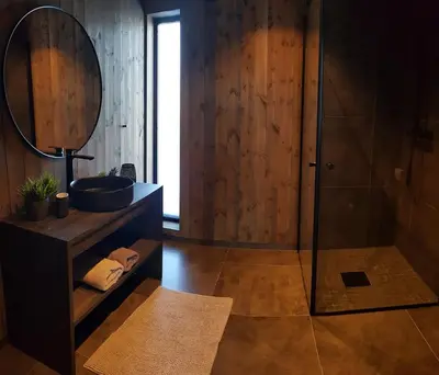 a bathroom with a shower and a sink and a mirror at Luxury Mountain Cabin Modern and Stylish in Uppheim