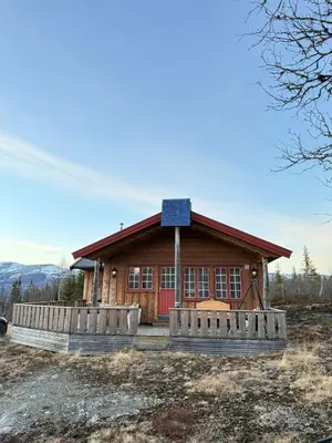 a house with a solar panel on top of it at Spacious mountain cabin in Valdres with 3 bedrooms in Vevle