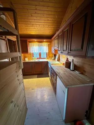 a kitchen with wooden cabinets and a counter top at Spacious mountain cabin in Valdres with 3 bedrooms in Vevle