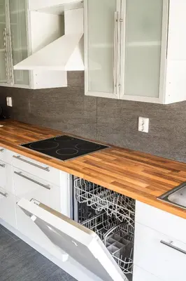 a kitchen with white cabinets and a stove top oven at The Oak Courtyard