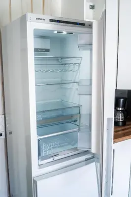 an empty refrigerator with its door open in a kitchen at The Oak Courtyard