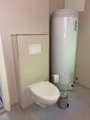 a bathroom with a white toilet in a room at Resting in Sauda