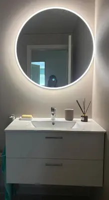 a bathroom with a white sink with a mirror at Resting in Sauda
