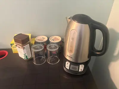 a coffeemaker sitting on top of a counter next to cups at Resting in Sauda