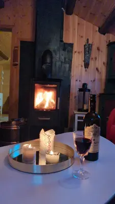 a table with a candle and a glass of wine at Nordseter Sjusjøen fiske, jakt, tur og ski in Lillehammer