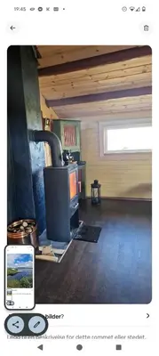 a living room with a stove in a room at Nordseter Sjusjøen fiske, jakt, tur og ski in Lillehammer