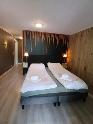 a bedroom with two beds and a wall with clothes at Apartment in Stryn in Stryn