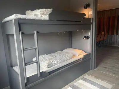 a bunk bed with a ladder on top of it at Modern 4-Bedroom Apartment in Beitostøl