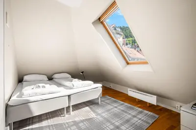 a white bedroom with a bed with a window at Charming Townhouse - Walk Everywhere! in Bergen