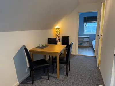 a dining room with a wooden table and chairs at Nylendo in Ulvik