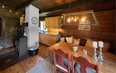 a kitchen and dining room with a table and a stove at 3 Bedroom Gorgeous Home In Nordberg in Nordberg