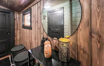 a room with a mirror and a table with chairs at 3 Bedroom Gorgeous Home In Nordberg in Nordberg