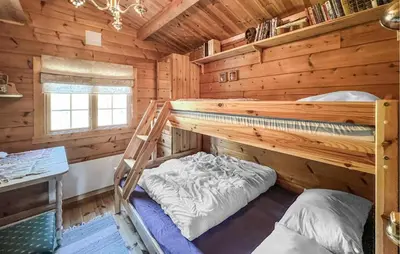 a bedroom with two bunk beds in a log cabin at 3 Bedroom Gorgeous Home In Nordberg in Nordberg