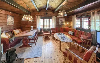 a living room with a couch and a table at 3 Bedroom Gorgeous Home In Nordberg in Nordberg