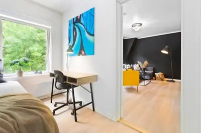 a bedroom with a desk and a window at Townhouse with free parking in the city centre - 4 bedrooms in Ålesund