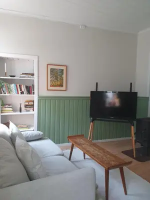 a living room with a couch and a piano at You cottage in the city in Bergen