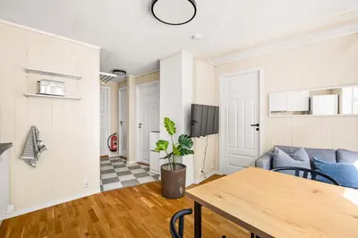 a living room with a table and a couch at Bergen Charm - Right in the City Center! in Bergen