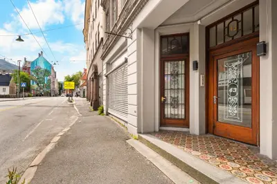 a building with a door on the side of a street at BB Apartments I 300m to Bryggen & Train Station in Bergen