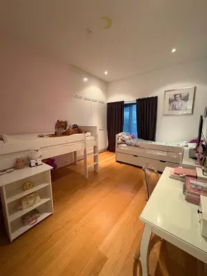 a room with two bunk beds and a desk at Exclusive seafront villa in Ålesund