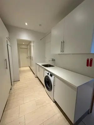 a kitchen with a washer and dryer in it at Exclusive seafront villa in Ålesund