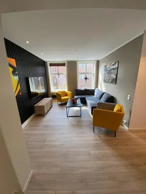 a living room with a couch and chairs at 4 bedroom apartment in Ålesund City in Ålesund