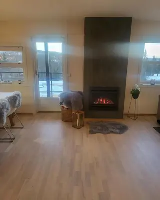 a living room with a fireplace and a fire place at Synnseter, Synnfjellet, Fjellstuguvegen 38, 2880 Nord Torpa in Lii