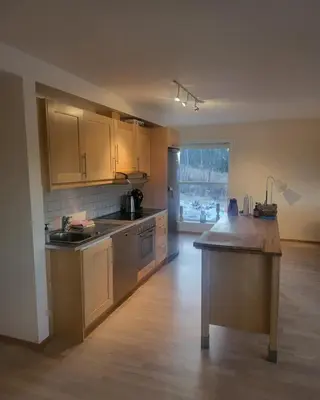 an empty kitchen with a island in the middle of a room at Synnseter, Synnfjellet, Fjellstuguvegen 38, 2880 Nord Torpa in Lii