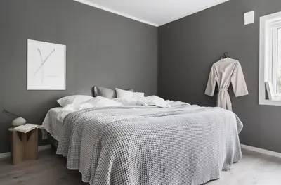 a bedroom with a bed with a black and white blanket at Cozy apartment at Laksevåg! in Bergen
