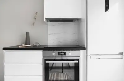 a kitchen with a stove and a counter top at Cozy apartment at Laksevåg! in Bergen