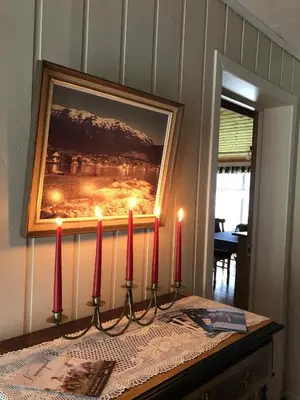 a group of red candles on a table with a picture at Stall Rygg Apartment, Gloppen