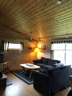 a living room with a couch and a table at Stall Rygg Apartment, Gloppen