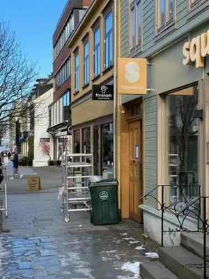 a street with a store on the side of a building at Central and Spacious Apartment for 6 in Trondheim