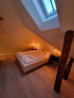 a bedroom with a bed and a skylight at Central Studio for 2 in Trondheim