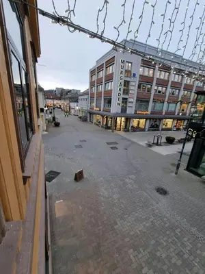 an empty street in a city with a building at Central Studio for 2 in Trondheim