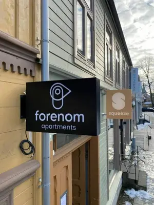 a sign on a building that reads forron departments at Central Studio for 2 in Trondheim