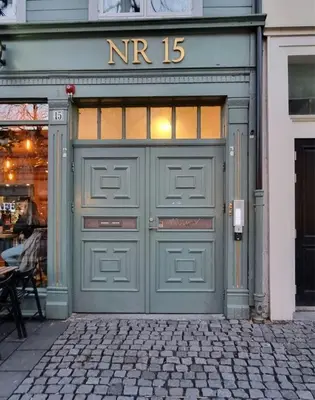 a green garage door with the number on it at Central Apartment for 4 in Trondheim