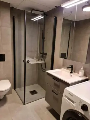 a bathroom with a shower and a toilet and a sink at Central Apartment for 4 in Trondheim