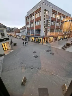 an empty street in front of a large building at Central and Spacious Apartment for 8 in Trondheim