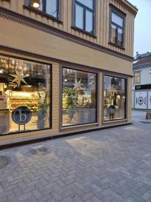 a store front with large windows on a street at Central and Spacious Apartment for 8 in Trondheim