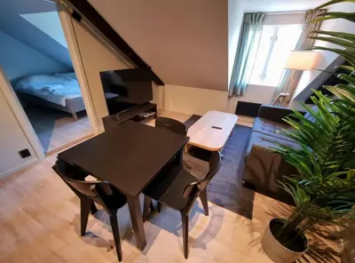 a living room with a table and a couch at Central Apartment for 2 in Trondheim