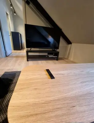 a large flat screen tv sitting in a living room at Central Apartment for 2 in Trondheim