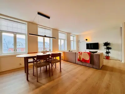 a living room with a table and a couch at Central apartment in Trondheim in Trondheim